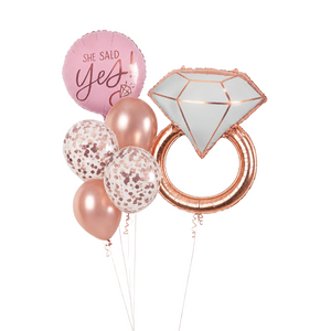 She Said Yes engagement balloon bouquet featuring a diamond ring foil balloon, She Said Yes foil balloon, rose gold chrome balloons, and rose gold confetti balloons for proposal and bridal shower decorations.